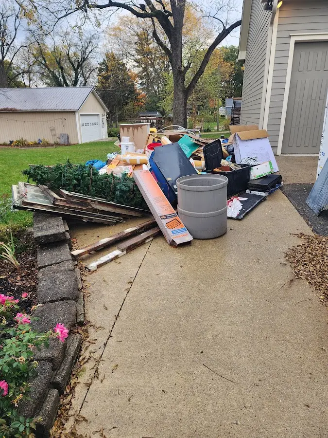 Dumpster being loaded with debris for Estate Cleanout Dumpster Rental in St. George
